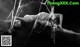 A black and white photo of a woman laying on a spider web.