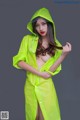 A woman in a yellow raincoat posing for a picture.