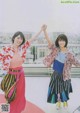 A couple of women standing next to each other on top of a roof.