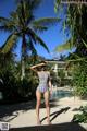 A woman in a bathing suit standing in front of a pool.