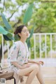 A woman sitting on a chair on a wooden deck.